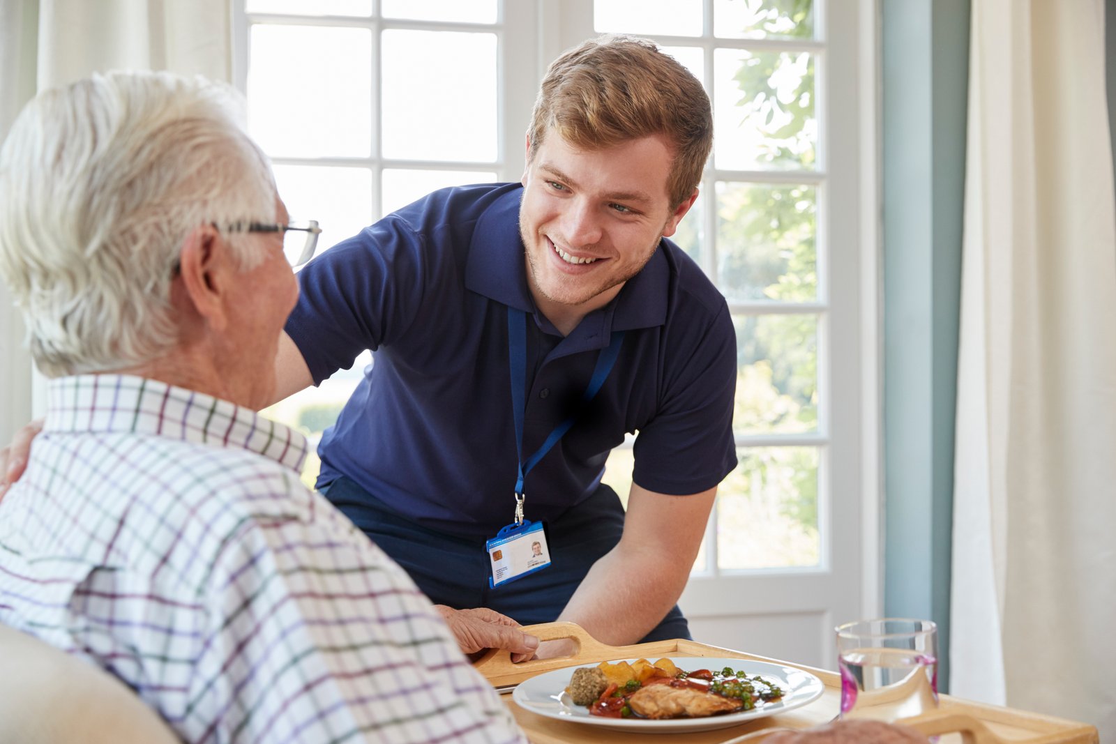 An in-home carer checking on a patient