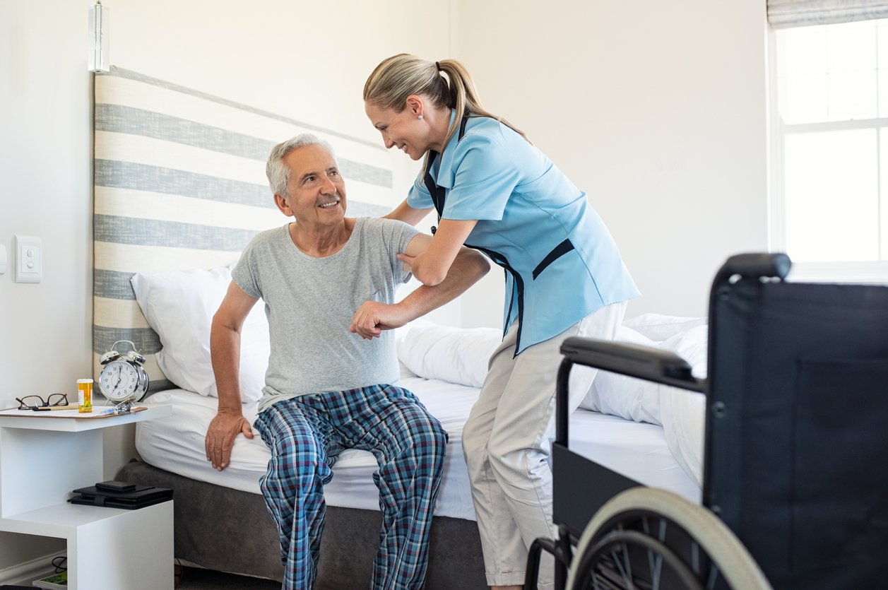 CNA nurse helping a patient.