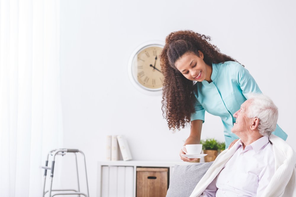 Home health nurse caring for a patient