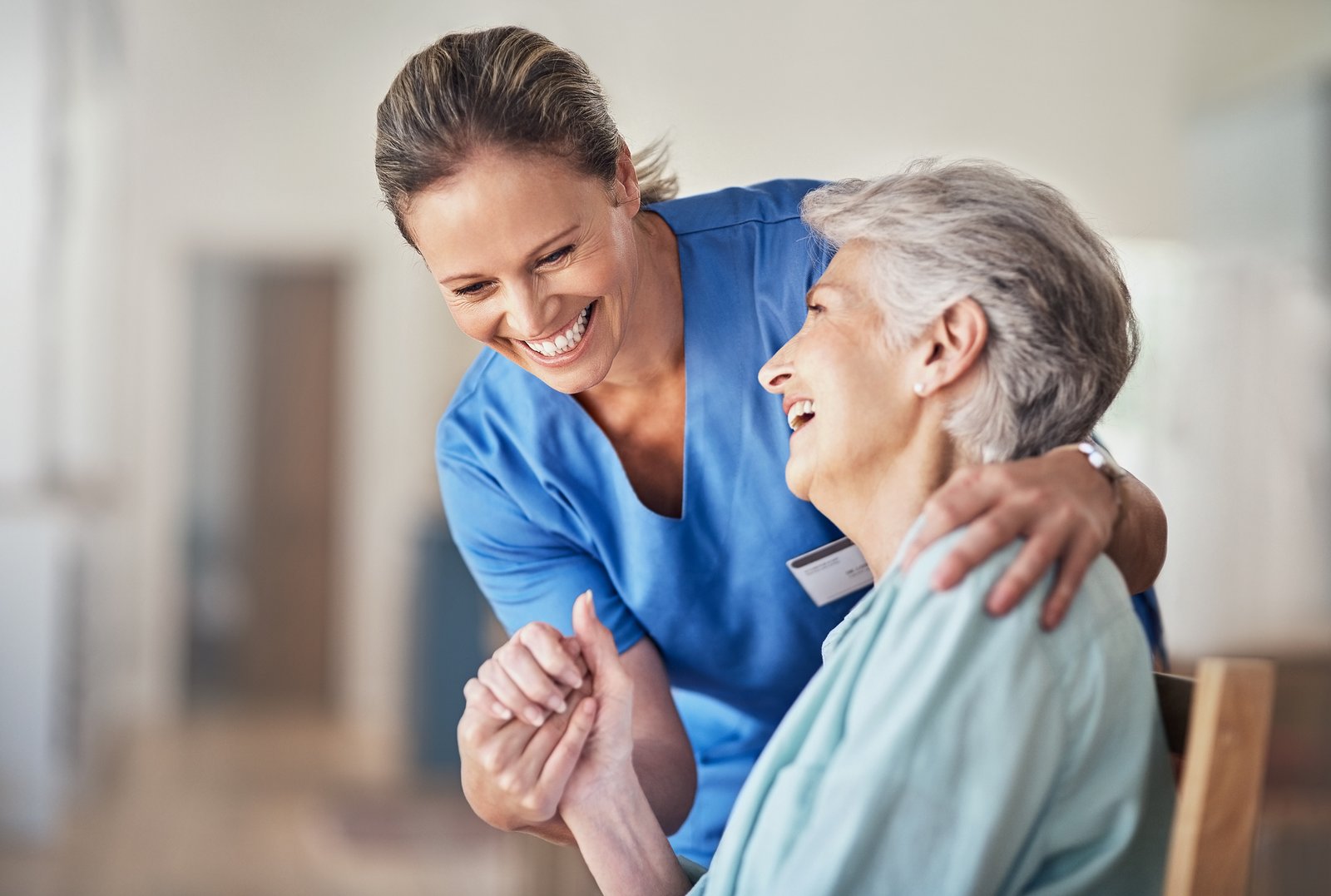 Home care nurse smiling with a patient