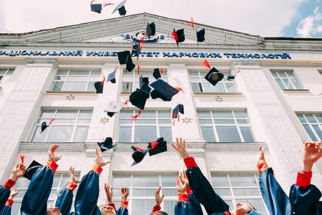 Nursing students at graduation, throwing their caps in the air.