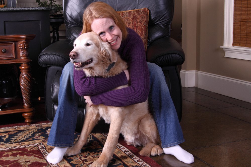 An EmpowerCare employee relaxing with their dog