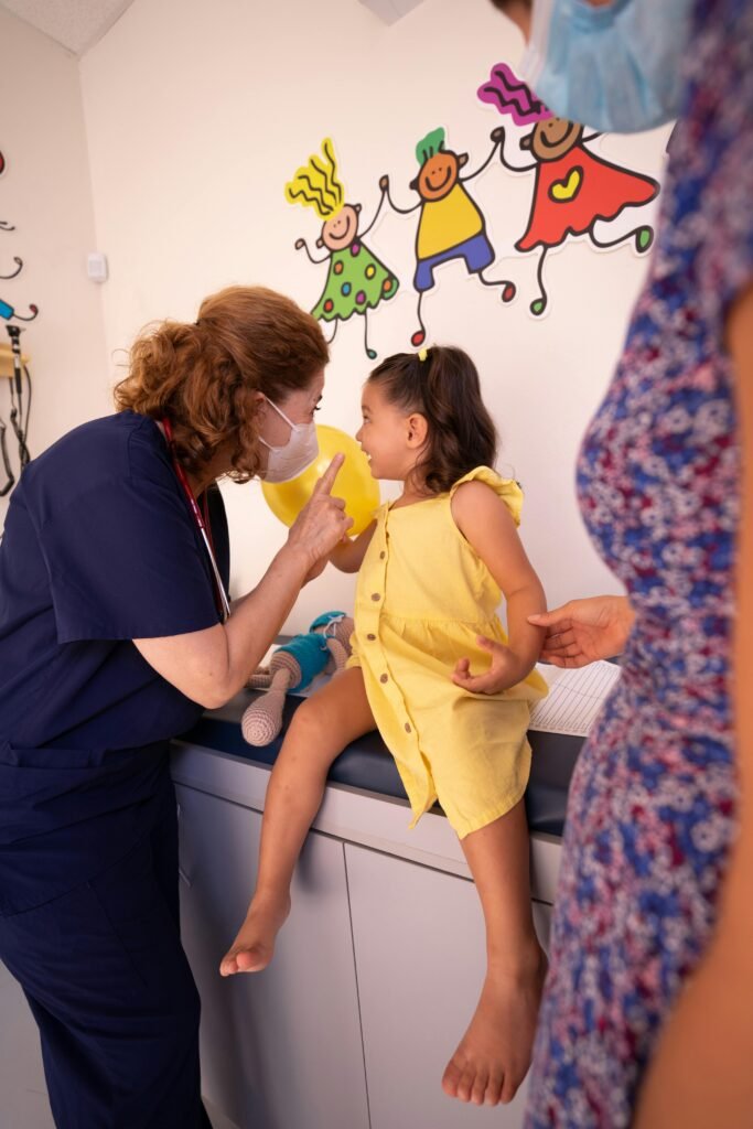 school nurse working with a child patient