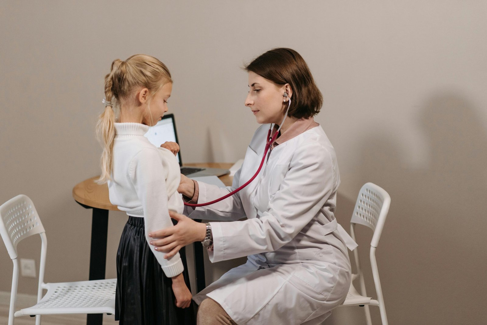 A school nurse helping a student.